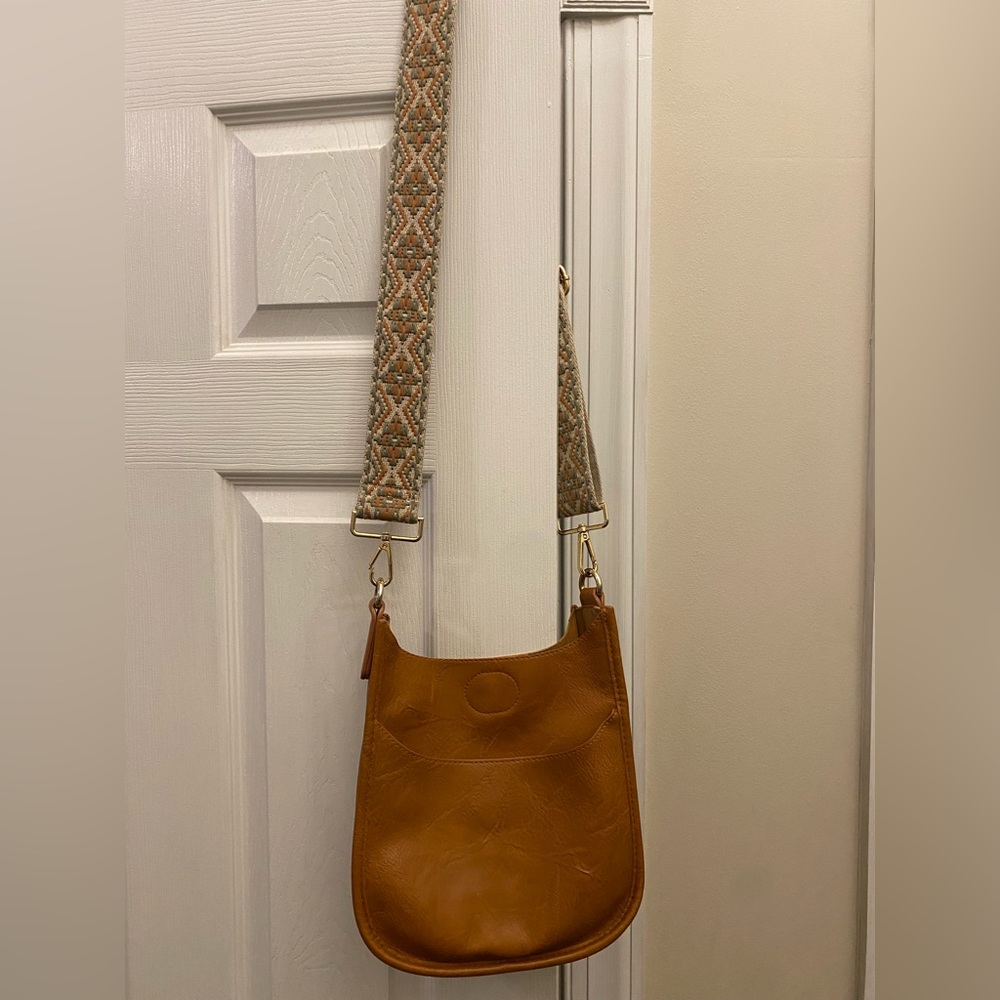 Used Ah-dorned tan cross body purse with strap in great condition.